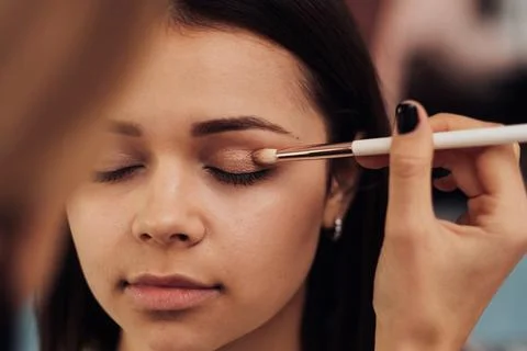 Close Up Make Up Artist Working with Client Eyelid, Young Woman at Procedure in Stock Photos