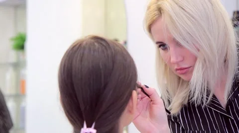 Close-up make-up artist's face in working with model Stock Footage 68717811