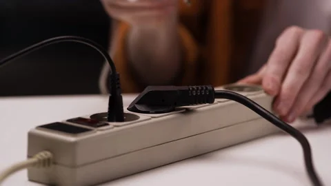 Close-up of make hand plugging the power plug. outlet sockets at home Stock Footage 309038288