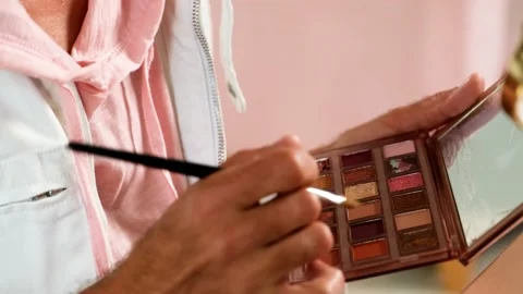Close-up of make-up tools in male hands &amp; Professional eye shadow palette Stock Footage 161833740