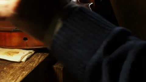Close up of maker carefully varnishing violin ribs using brush with self made Stock Footage 304641895