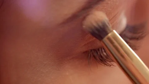 Close up of makeup artist is applying eyeshadow powder on the woman's eyelid. Vidéo 82709634