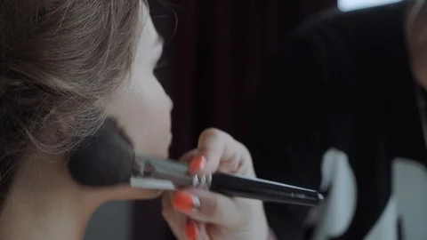 Close up makeup artist doing visage to young woman in beauty salon. Beautician Stock Footage 104053822