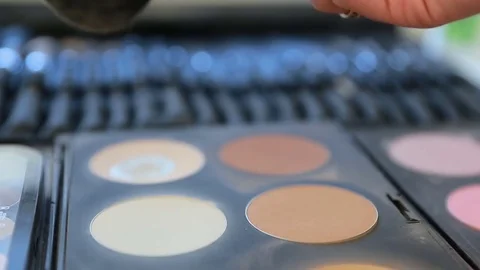 Close up of a makeup artist using a color from the makeup palette Stock Footage 74582577