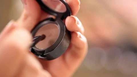 Close up of makeup brush moving over eye shadows Stock Footage 69832692