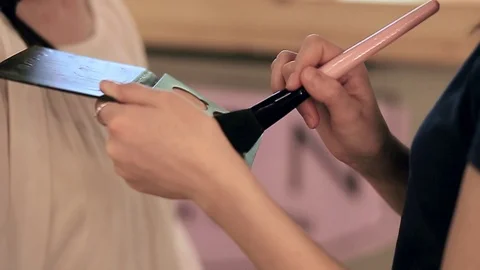 Close up of makeup brush moving over palette rouge in slow motion 動画素材 76081655