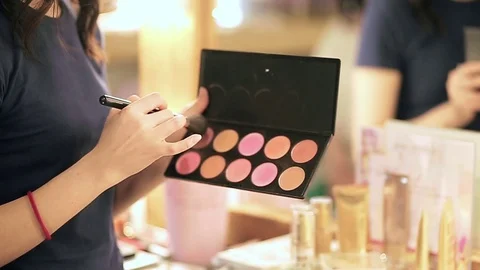 Close up of makeup brush moving over palette rouge in slow motion Stock Footage 76081821
