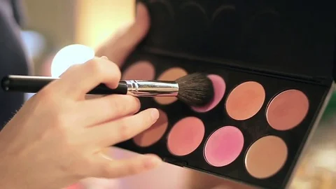 Close up of makeup brush moving over palette rouge in slow motion Stock Footage 76081825
