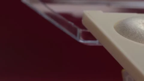 Close up of makeup brush resting on shimmering powder palette with soft pink Vidéo 343968286