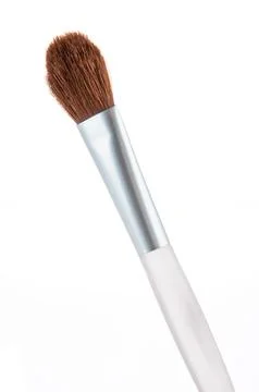 Close-up of a makeup brush with white handle and brown bristles Stock Photos
