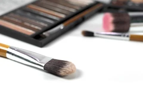 Close up makeup brushes with eye shadows palette and brushes background Stock Photos