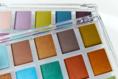 Close-up of makeup palettes. Eye shadow palettes on a light background. Stock Photos