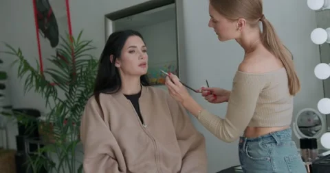 Close-up of the makeup process by a makeup artist on a client in a beauty salon Video stock 324819914