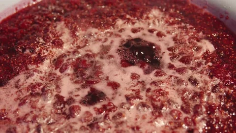 Close-up of a making appetizing raspberry jam at home on the stove. Stock Footage 219429282