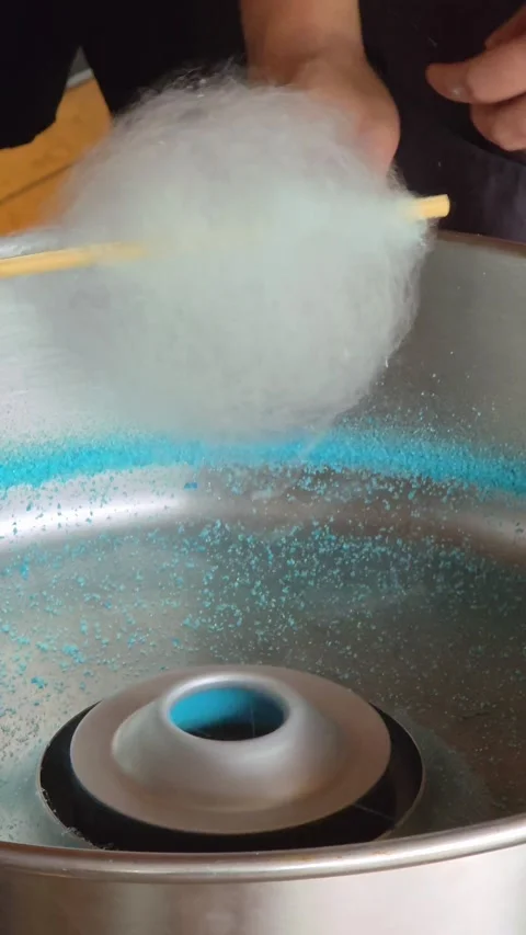 Close Up of Making Blue Cotton Candy in a Spinning Machine Stock Footage 316873359