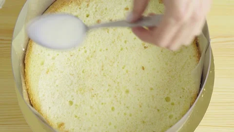 Close-up of making a cake. impregnation of sponge cake with milk. Stock Footage 132320175