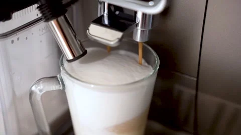 Close-up of making cappuccino or latte in an automatic coffee machine Stock Footage 247277478