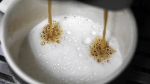 Close-up of making cappuccino using a coffee machine.  Video stock 260899411