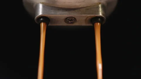 Close up making espresso Flowing fresh ground coffee. Pouring coffee stream from Stock Footage 194795488