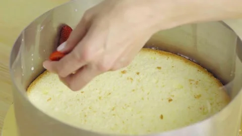 Close-up of making a frieze cake. applying strawberries on a sponge cake. Stock Footage 132320277