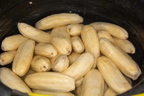 Close up of making a light snack of yellow banana chips Stock Photos