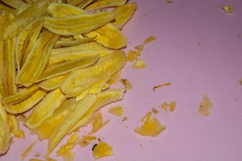 Close up of making a light snack of yellow banana chips Stock Photos