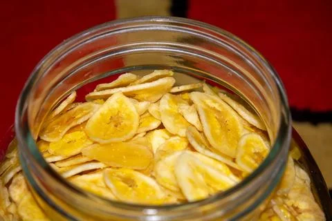 Close up of making a light snack of yellow banana chips Stock Photos