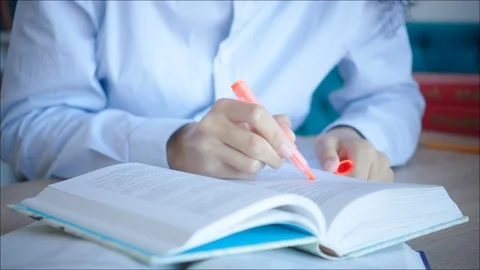 Close up making marks in textbooks while preparing for exam Stock Footage 104416691