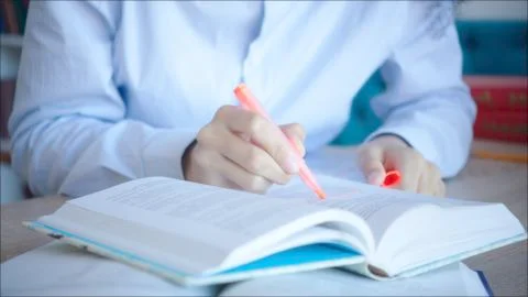 Close up making marks in textbooks while preparing for exam 스톡 사진