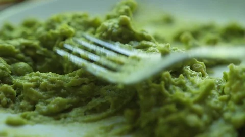 Close up of making mashed avocado with fork for guacamole or bruschetta Video stock 127842238