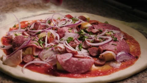Close up of making pizza. The the cook sprinkles herbs on the pizza. Slow motion Stock Footage 232414490