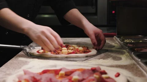 Close up of making pizza. The cook takes pizza to put it to stove. three pizzas Stock Footage 232410217