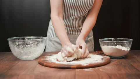 Close-up of making pizza dough, preparing and mixing the dough with flour in 4K. Stock Footage 137426727