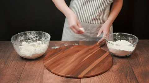 Close-up of making pizza dough, preparing and mixing the dough with flour in 4K. Stock Footage 137426894