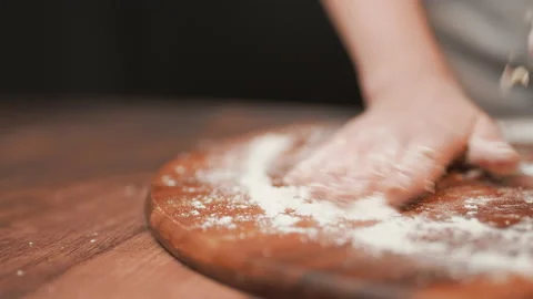 Close-up of making pizza dough, preparing and mixing the dough with flour in 4K. Stock Footage 137427361