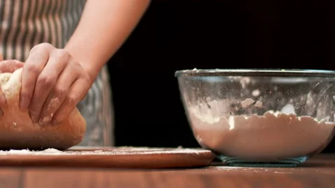 Close-up of making pizza dough, preparing and mixing the dough with flour in 4K. Stock Footage 137427796
