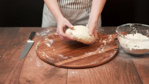 Close-up of making pizza dough, preparing and mixing the dough with flour in 4K. Stock Footage 137428603