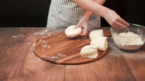 Close-up of making pizza dough, preparing and mixing the dough with flour in 4K. Stock Footage 137428970
