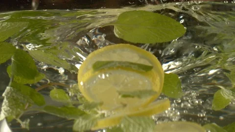 Close-up of making refreshing summer lemonade with mint and lemon in large pot Stock Footage 116157127