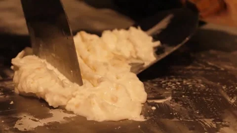 Close-Up of Making Rolled Ice Cream on a Cold Plate Video stock 345293121