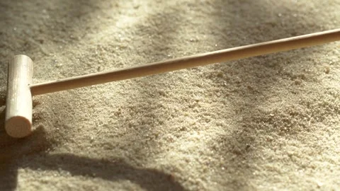 Close-up making sand zen garden using mini wooden rake with shadows and sunlight Stock-Footage 264940663