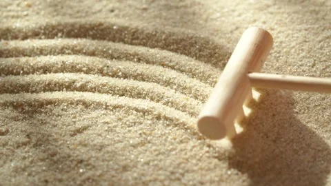 Close-up making zen garden with sand and stone using mini bamboo wooden rake Stock Footage 270894992