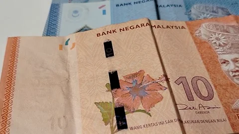 Close-up of Malaysian 1 Ringgit and 10 Ringgit banknotes Stock Footage 335643812