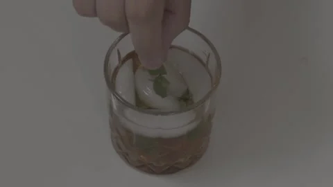 Close Up Male Adding A Mint Garnish To An Old Fashioned Stock Footage 152783777