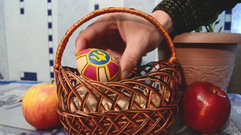 Close-up male arms putting Easter egg into basket,preparation to Eas Stock Footage 178039772