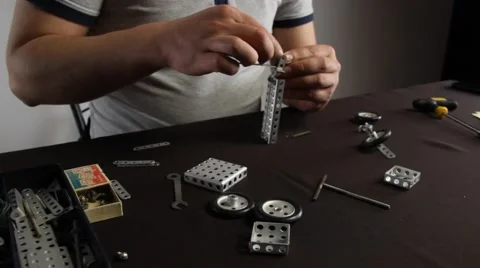 Close up of Male Assembling Construction Toy Stock Footage 51347848