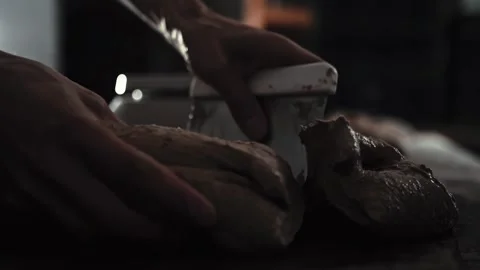 Close-up male baker hands divide dough using scraper. Dough portions prepared Stock Footage 342230392