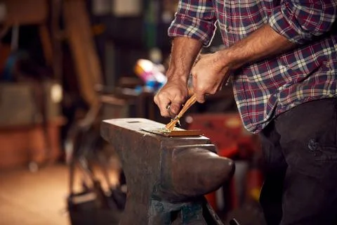 Close Up Of Male Blacksmith Making Wood Shavings With Knife For Kindling On Stock Photos