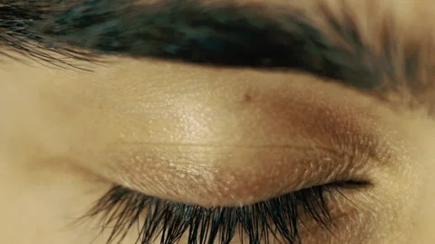 Close up of male blue eye opens up and closes Stock Footage 146987908
