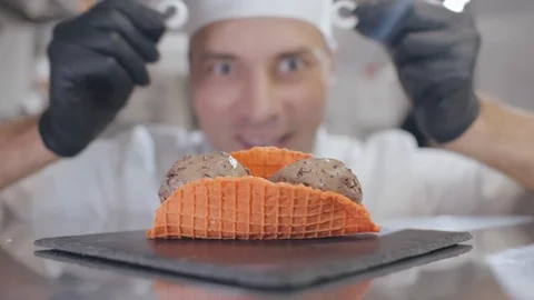 Close up of male chef adding decorations on waffle ice cream dessert Stock Footage 125051385
